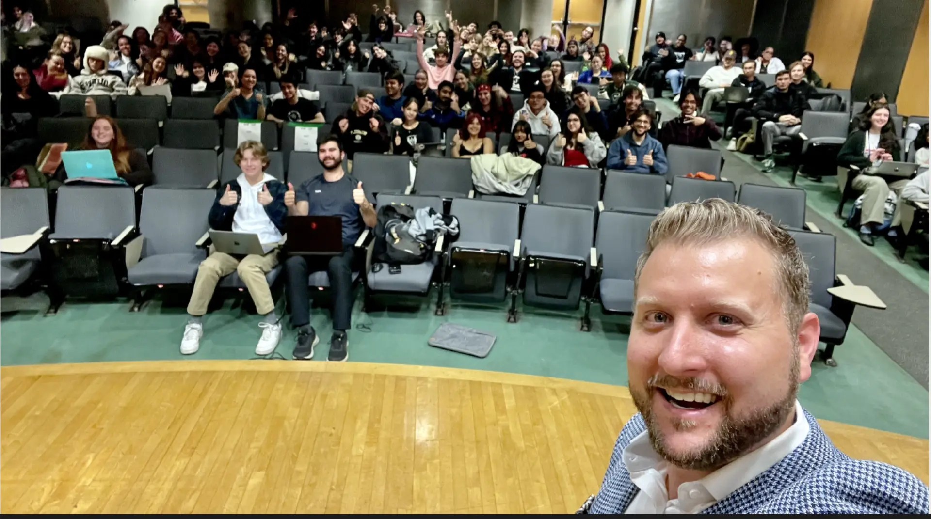 Corey Peck with a lecture hall audience after a live training session