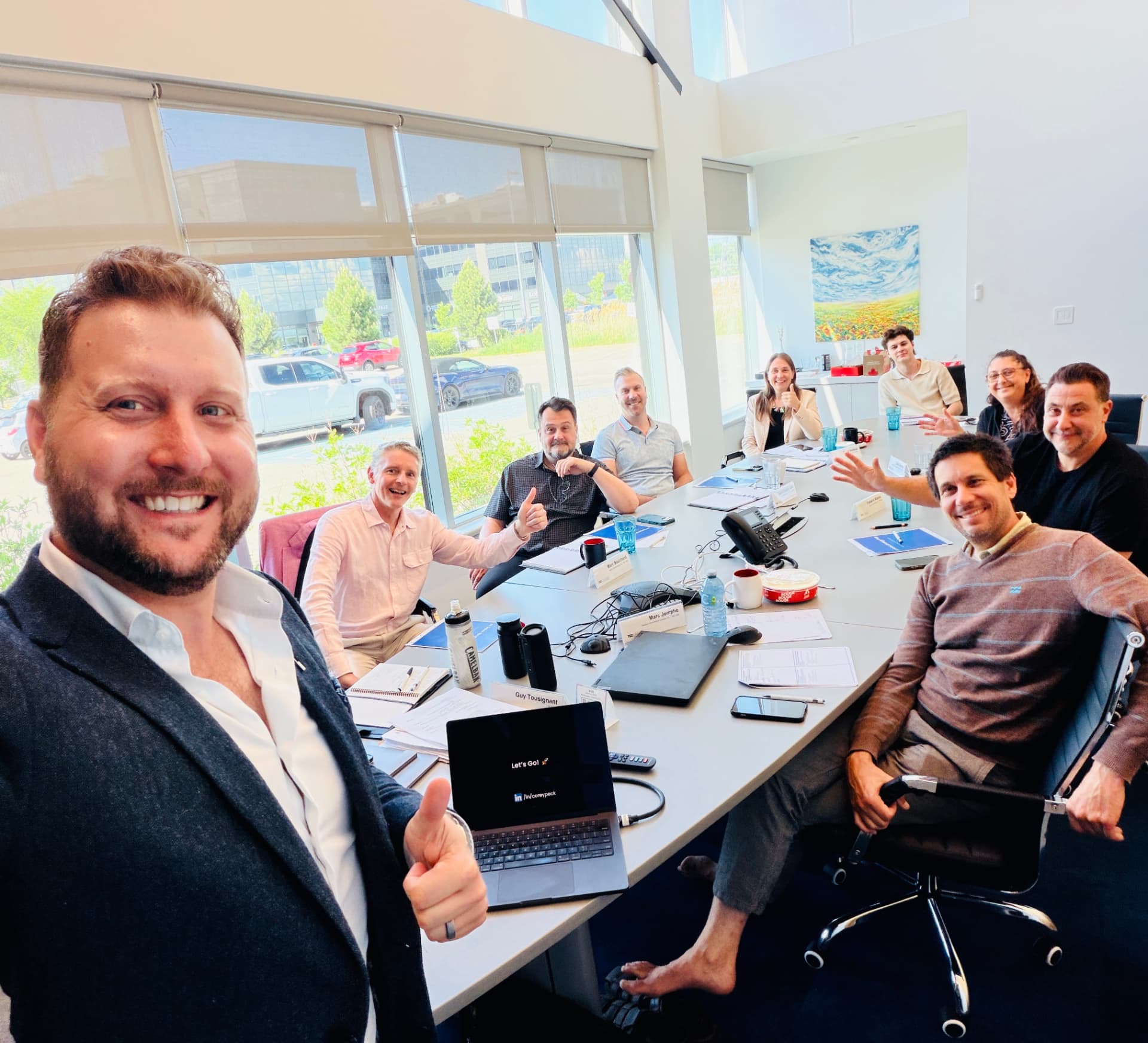 Corey Peck with an executive team during a workshop session around a boardroom table